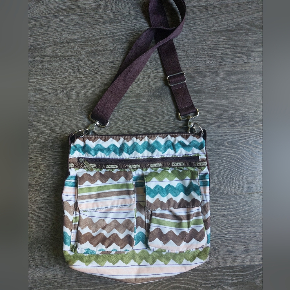 Lesportsac crossbody bag with a great zigzag print. White brown teal green